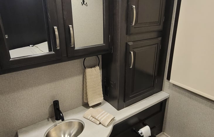 Large Master Bathroom with plenty of storage and porcelain toilet for comforts and feel of home. Two rolls of toilet paper included.  Please use sparingly to be kind to the septic system.