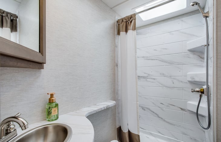 On demand water heater. Nice sized shower! There is an outdoor shower as well.