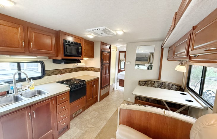 Gas stove/oven, microwave, sink and gas/electric fridge