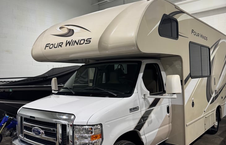Front of RV. Large windshield with no cracks or scratches. Wide mirrors that are foldable for you to utilize space when not driving.