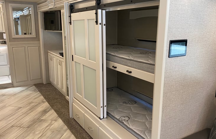 Bunk area, upper bunk can be folded up to create a very large wardrobe closet.