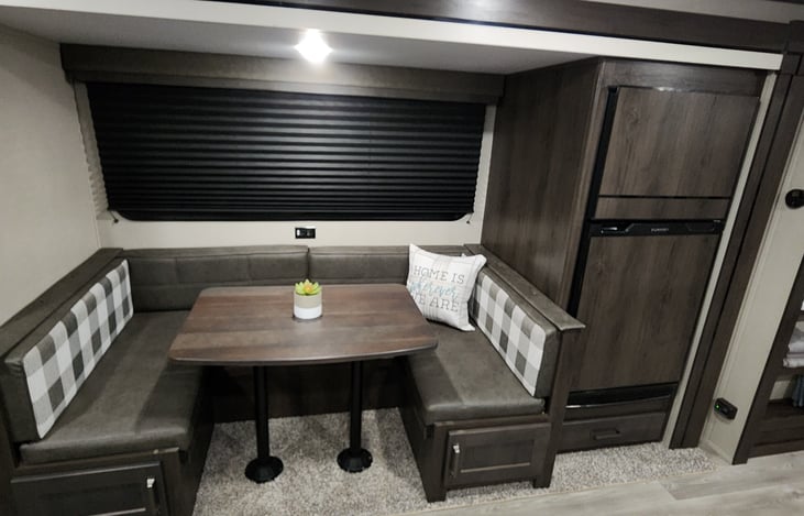 U-shaped dining table folds down into a bed. X-large capacity mini-fridge/separate freezer!