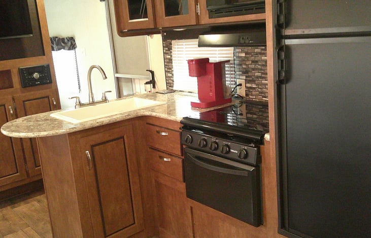 Full kitchen with 3 burner cook top, oven, freezer, refrigerator, microwave and Keurig coffee maker
