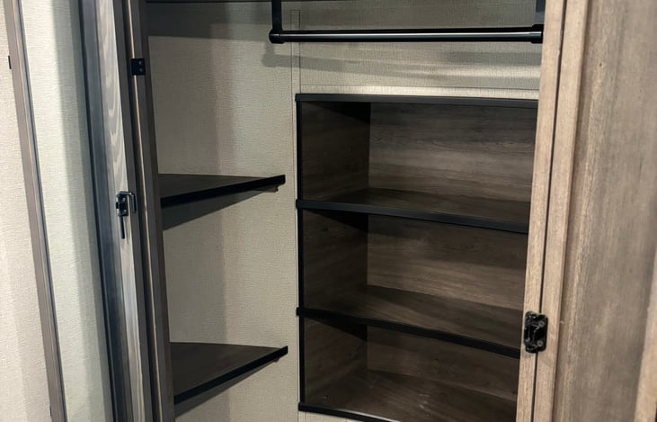 Plenty of space, shelving, and hanging room. This closet always reminds me of a mini walk-in closet. Its the second of two closets in the bedroom and is over top of the fifth wheel hitch