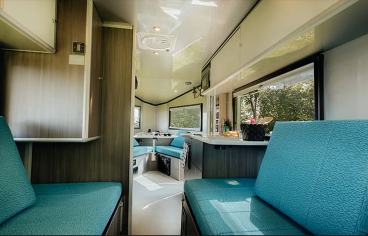 From back looking toward front. Overhead storage plus underneath kitchen sink and stovetop. Closet at left.