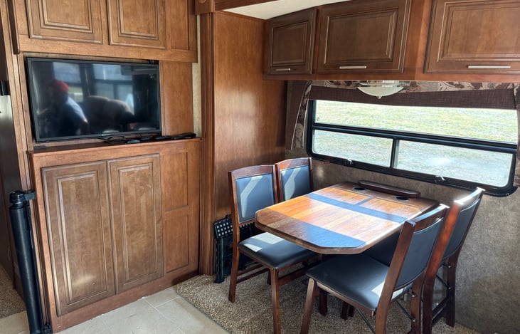 Living room television with Roku. Four person dining table.