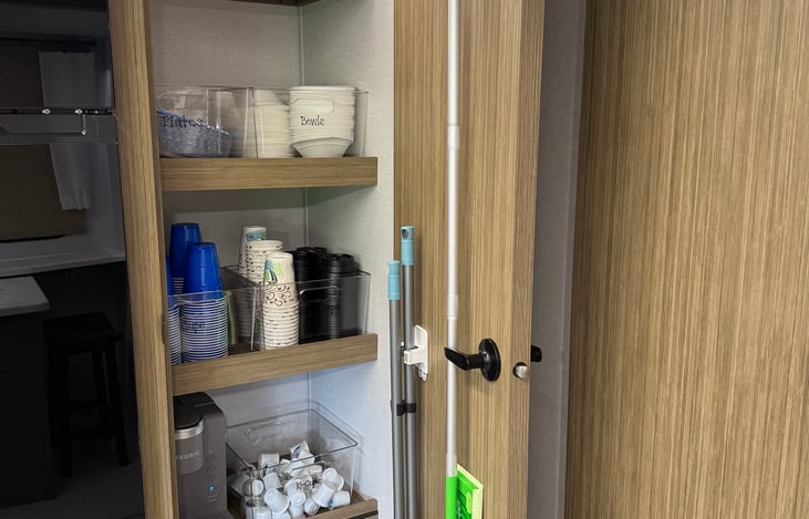 Pantry with coffee maker, coffee cups, K-cups, disposable plates, cups, bowls snd paper towels provided.