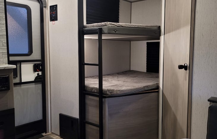 Bunk bed area. Each bunk a full size and contains a usb port.