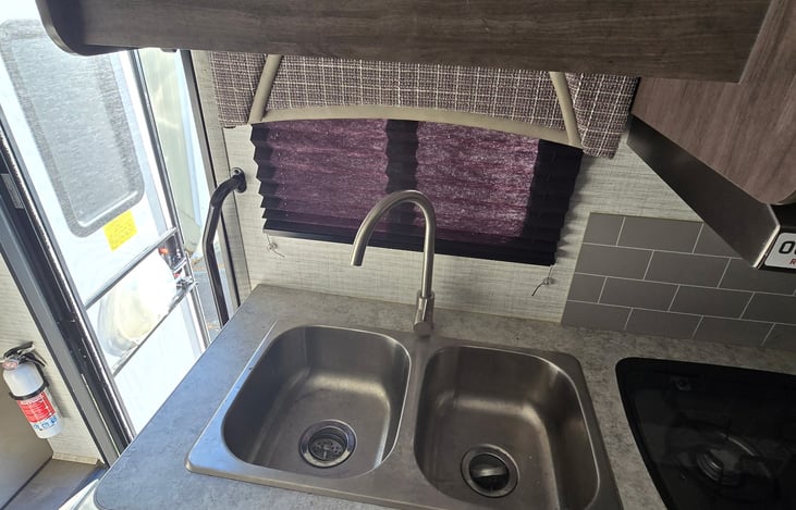 Kitchen sink w/ storage cabinets above