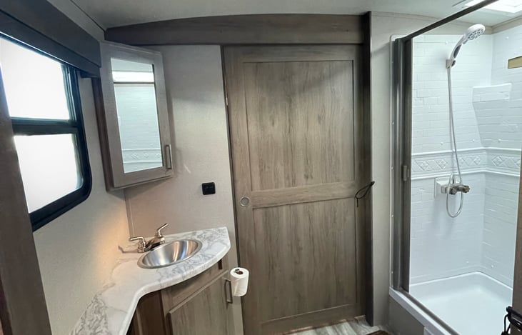 Bathroom sink, toilet, and shower.