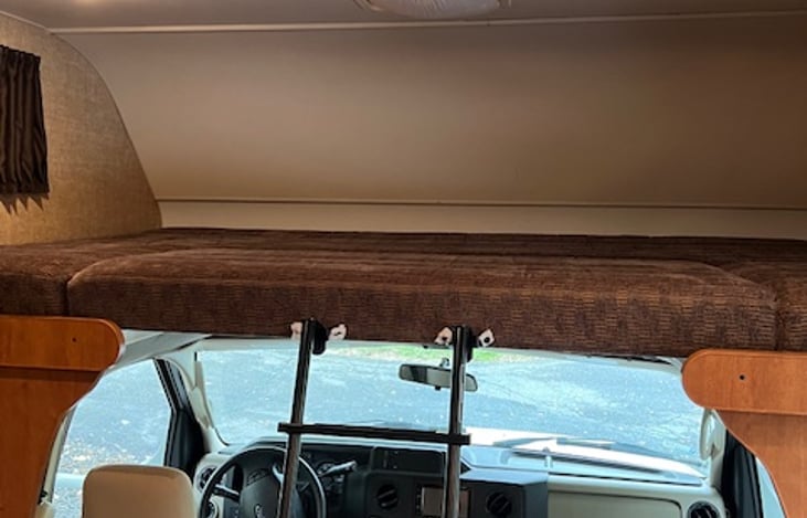 Cabover bed has a window and air conditioning vent