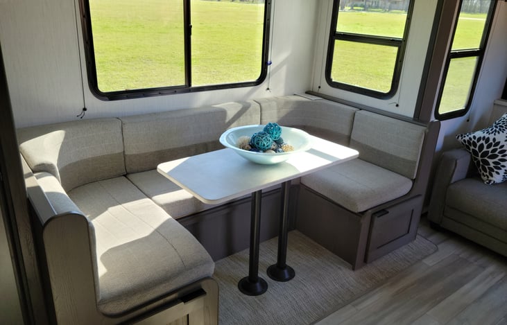 Large kitchen dinette that converts to an extra bed.