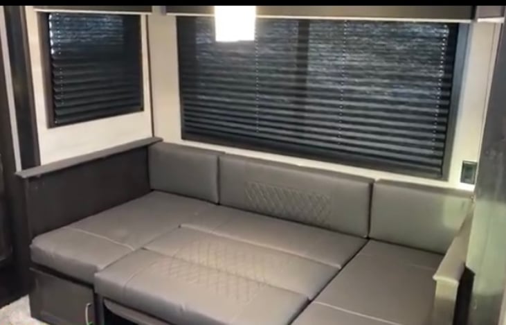 u-shaped dinette converted into additional sleeping area