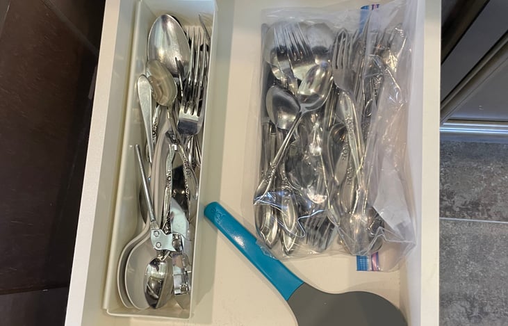 Forks, spoons, and spatula provided in the kitchen for cooking.