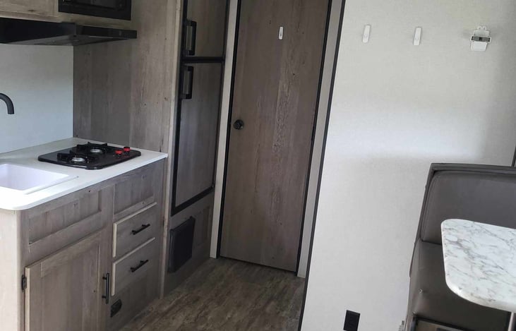 Kitchen area with full sized fridge.