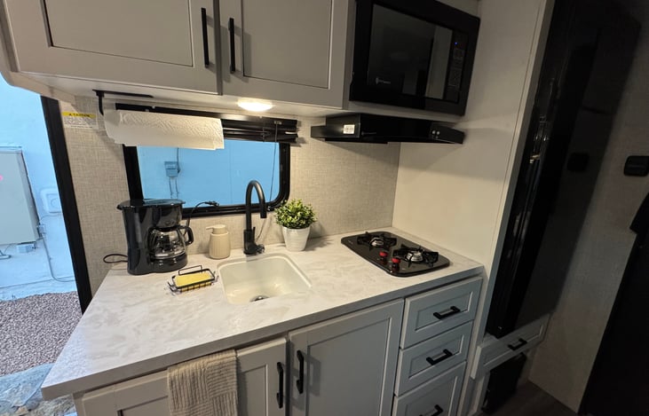 The RV comes fully equipped with what you need to cook, from utensils to appliances.