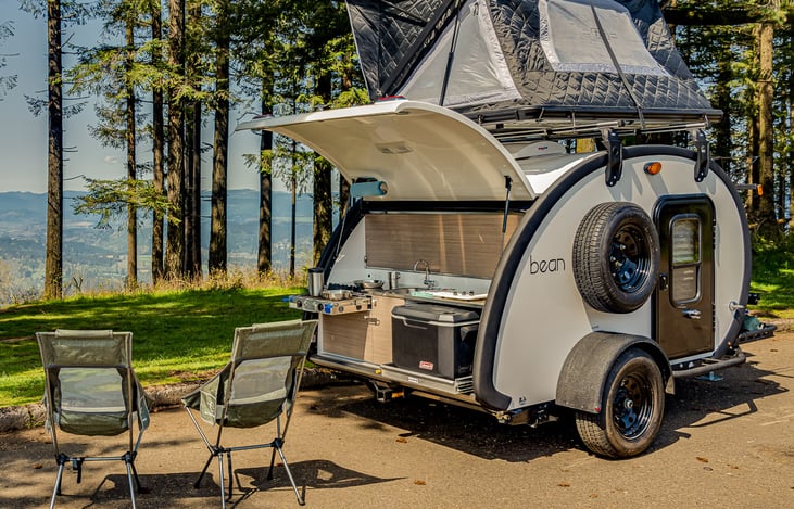 Cooking is so easy with the Galley Kitchen with built-in 2-burner Stove, 18 Gallon Water Tank + rack-out 50 qt. Cooler. NOTE: 40L Electric Fridge Included in Rental (but not shown in photo).
