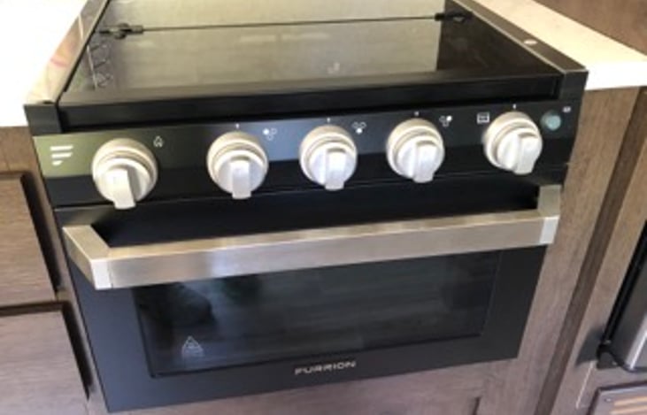 Gas stove with glass covers provides more prep space.