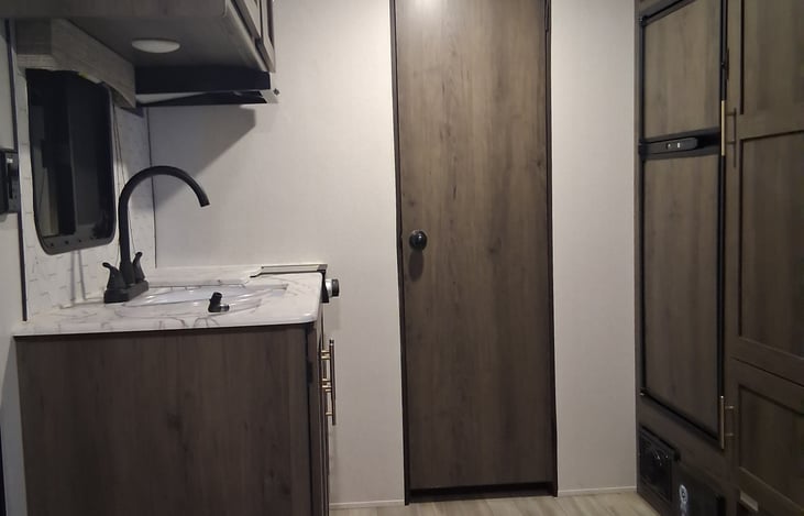 Lichen with sink, 2 burner stove and refrigerator/ freezer.