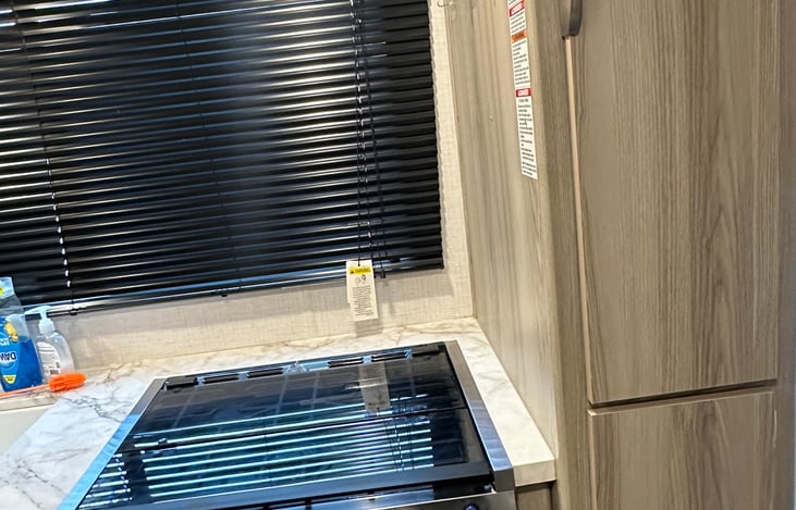 3 burner gas stove. Below is a combination microwave and convection oven.