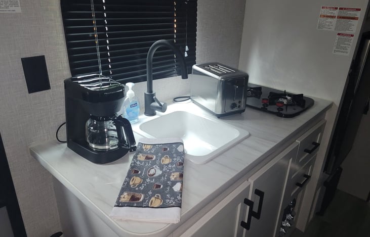 5 Cup coffee maker, toaster and flat griddle supplied. Two burner propane stove with skillet and sauce pan provided. All kitchen utensils included.