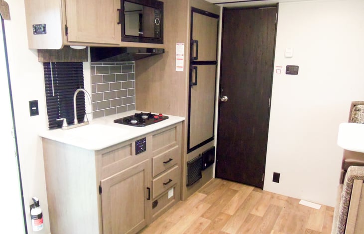 The kitchen with a full grown fridge and a propane stove top as well as a microwave.  But we all know you'll be cooking over the campfire any way :)