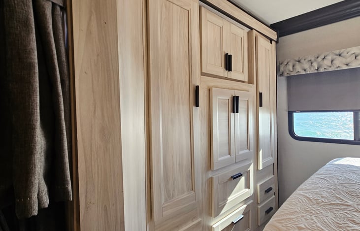 Master bedroom with double ward and multiple drawers for storage and 2 hanging racks