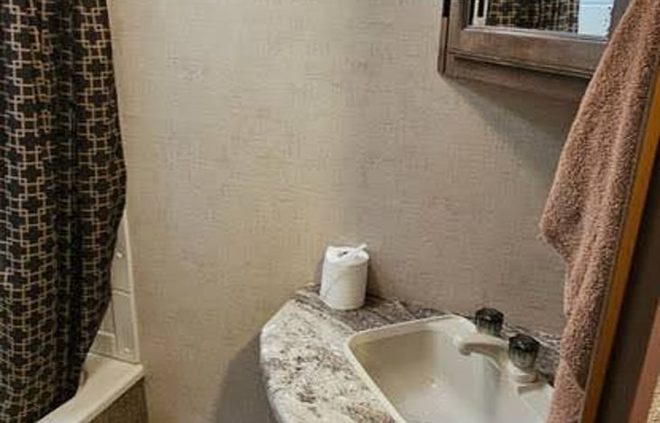 bathroom with shower and tub