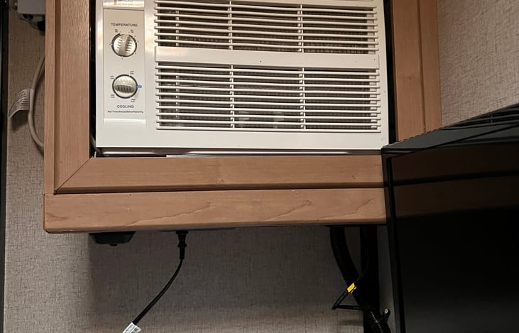 In addition to the standard AC unit, in the living area, there is a separate AC unit in the garage/bedroom.