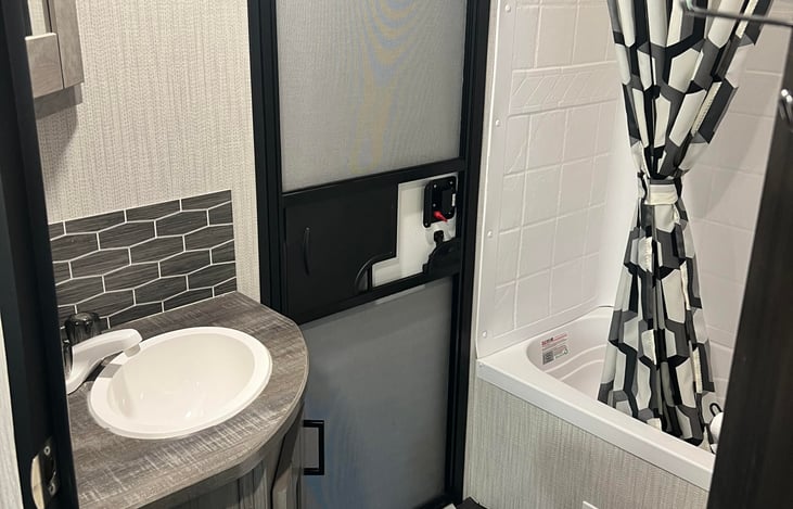Bathroom, with entry directly to outside. Shower, toilet and sink with a medicine cabinet full of everything you could need.