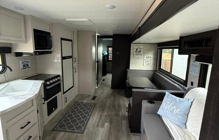 Two seat couch that converts to a pull out bed. U shaped dinette and fully functional kitchen.