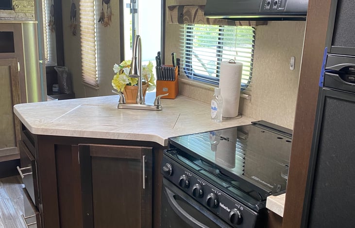 Large sink with retractable faucet and sprayer. Top to promote countertop space.