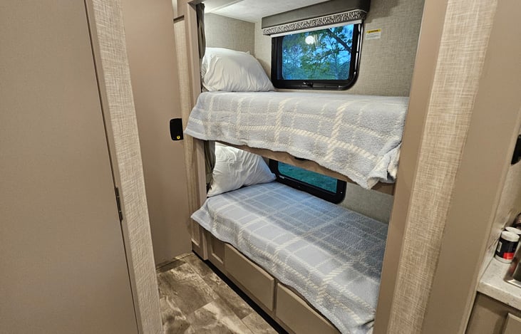 Bunk beds are 27"x72".  Each bunk has its own light and tablet holder to watch movies!