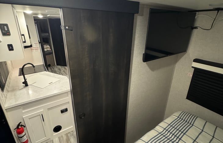 Sliding door and black out shades in main sleeping area