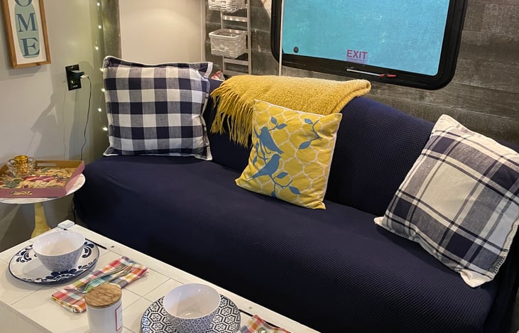 Lovely and inviting living room and dining room.  THe white truck serves as table for games, meals, and storage.