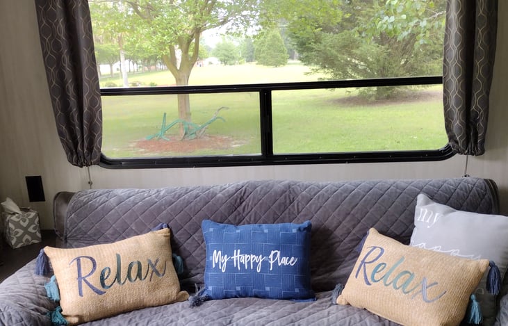 Rear living. Sofa that can be turned into an extra bed or just to sit and look out the window at nature. Ottoman also included to throw your feet up on while watching a little TV.