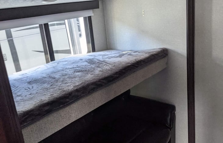 Top bunk and bottom bunk that folds into a double bed. Also there is a table that can be set up in this room and used.