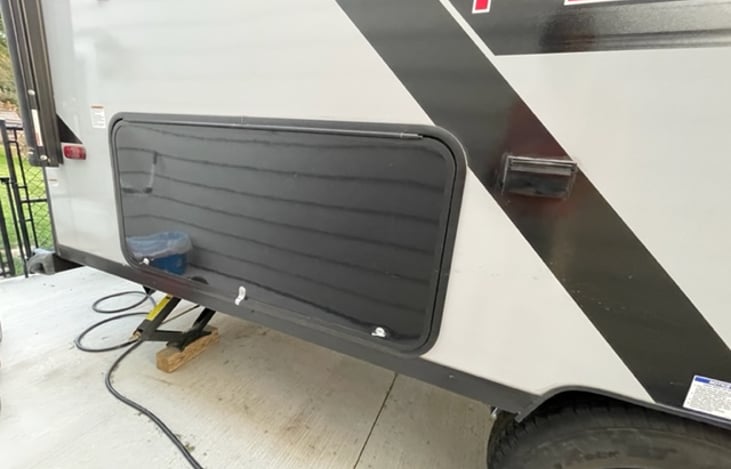 Right rear storage. Includes all potable water and electrical cables inside. BONUS mini fridge to hold any types of beverages you or your family to grab while sitting by the campfire!