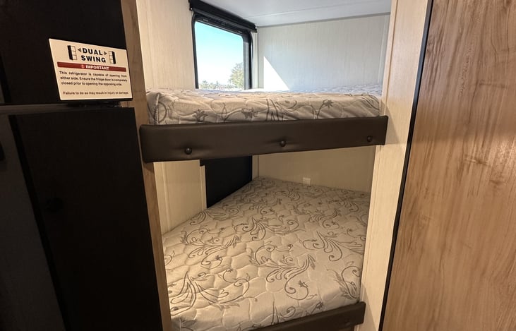 Rear double bunk beds for kids, guests, or extra sleeping space.