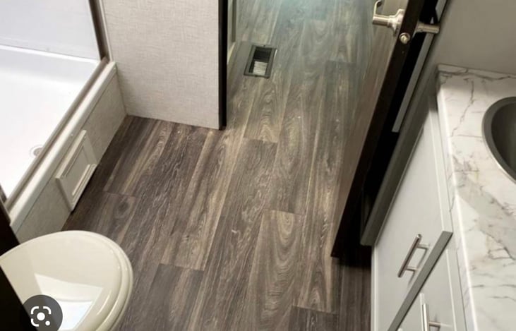 Spacious bathroom with walk-in shower and plenty of storage.