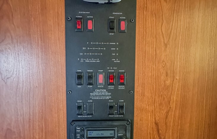 Coach control panel in the bathroom area: Slideouts, clean/gray/black/propane levels, and climate control.