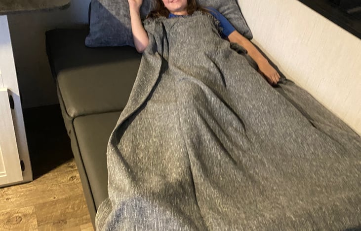 My daughter on the couch that expands to a couch- giving reference to the size. Small adult or older child.