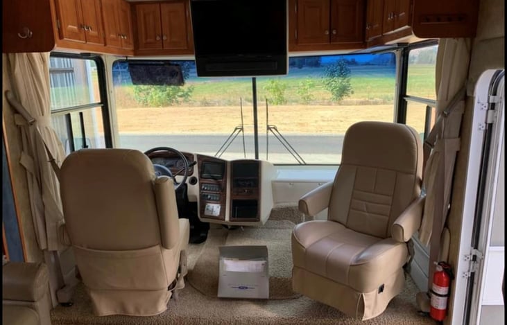 Captain's Chairs, with huge windows to view the adventures. Drapes to close at night for privacy.