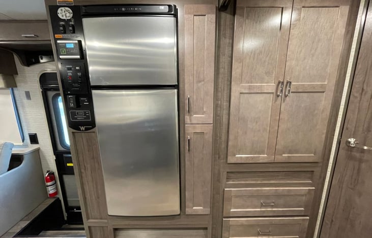 Reverse side of kitchen with convenient fridge and closet.