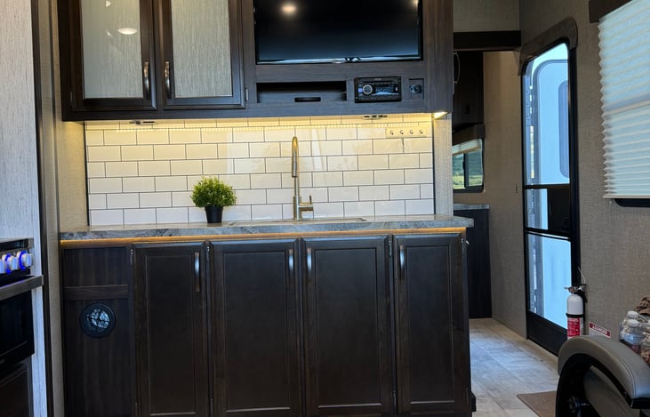 In the main living space there is an entertainment center complete with indoor and outdoor speakers. There is also a selection of DVD's to watch during your stay.