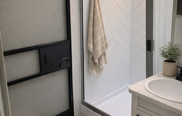 Easy in and out shower with hand wand.  There is also an access door in the bathroom.