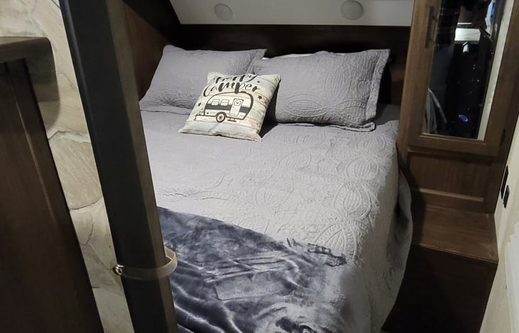 Very comfortable upgraded queen mattress. Sliding doors close for privacy. Two hanging clothes closets, two above the bed storage areas, and the bed lifts up for additional storage.