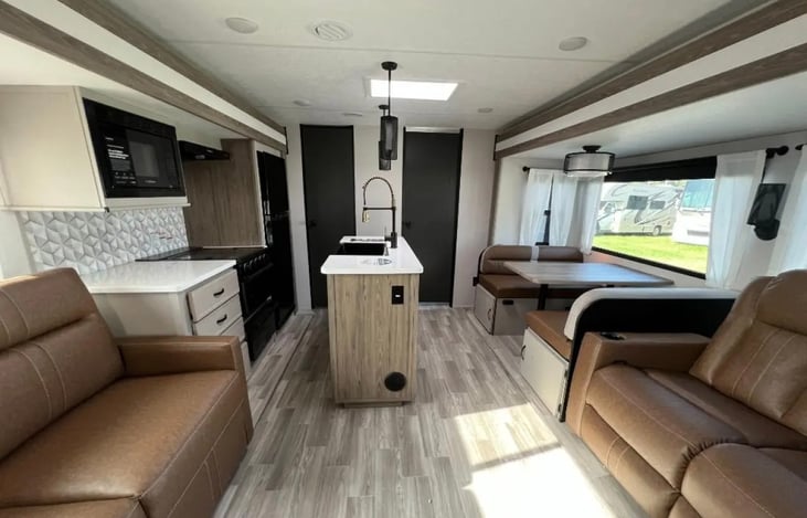 Common area with kitchen island, Dinette and 2 sofas
