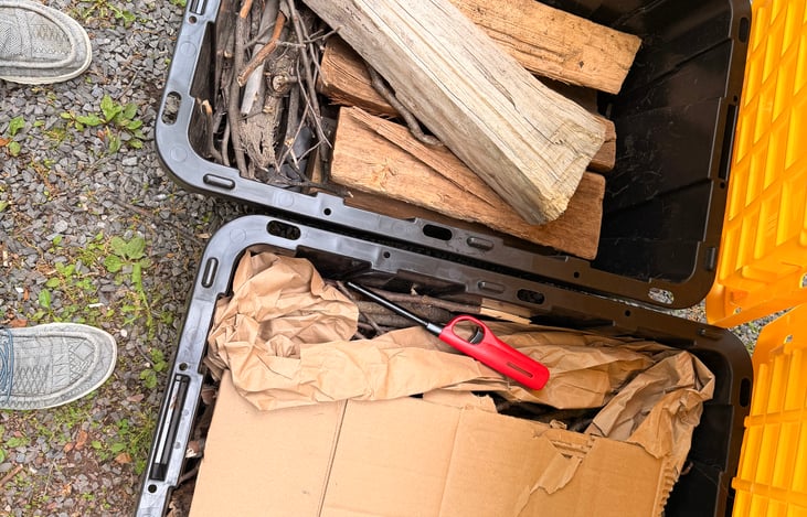 Two totes of wood/kindling/cardboard/paper to get you started for campfires during your trip