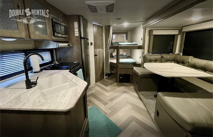 Spacious Floor Plan with L-Shaped Kitchen, Large Fridge, U-Shaped Dinette and Cozy Bunks that Could Fit 4 Kiddos!